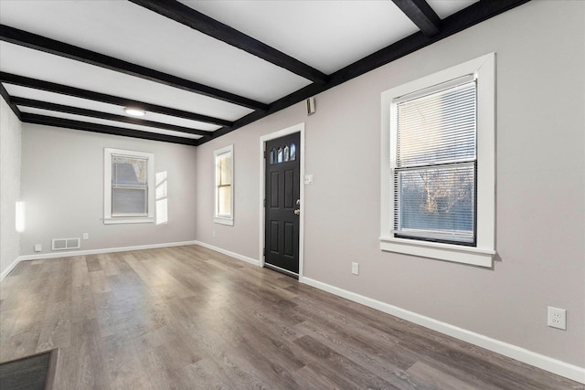 foyer featuring hardwood / wood-style flooring and beamed ceiling