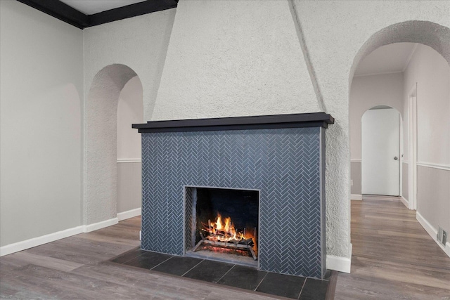 interior details with hardwood / wood-style flooring and a tile fireplace