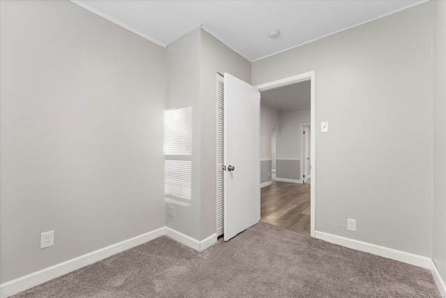 carpeted empty room with ornamental molding