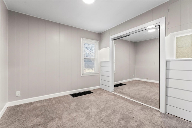 unfurnished bedroom featuring carpet floors and a closet