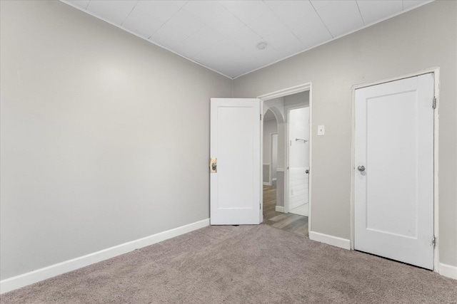 unfurnished bedroom with light colored carpet