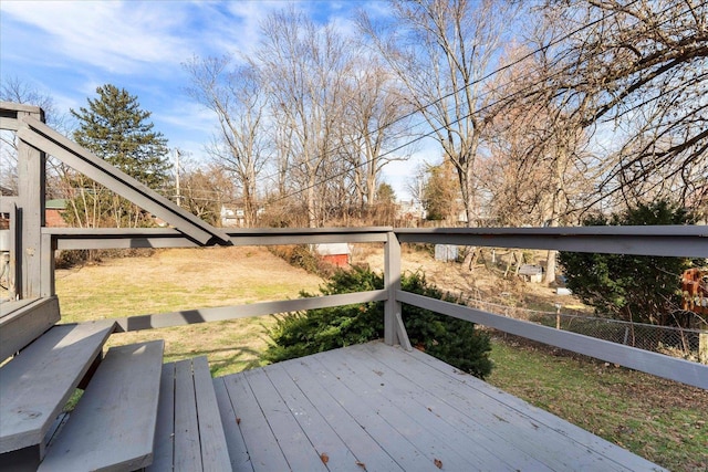 wooden deck featuring a yard