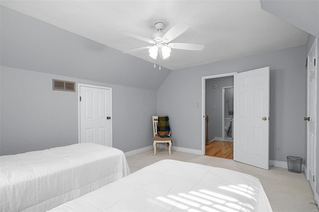 bedroom with light carpet, visible vents, baseboards, and vaulted ceiling