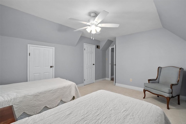 bedroom featuring light colored carpet, ceiling fan, baseboards, and vaulted ceiling