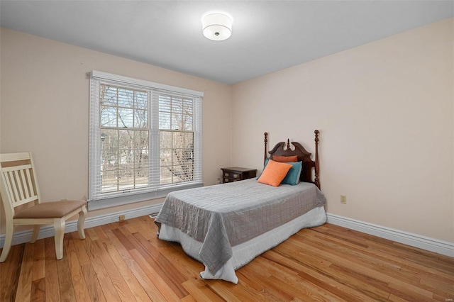 bedroom featuring baseboards and light wood-style floors