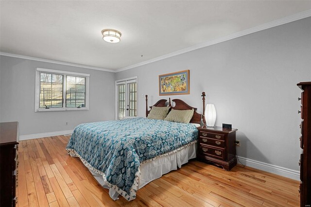 bedroom featuring baseboards, ornamental molding, and light wood finished floors