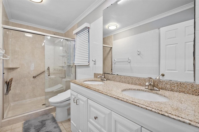 bathroom featuring crown molding, a shower stall, and a sink