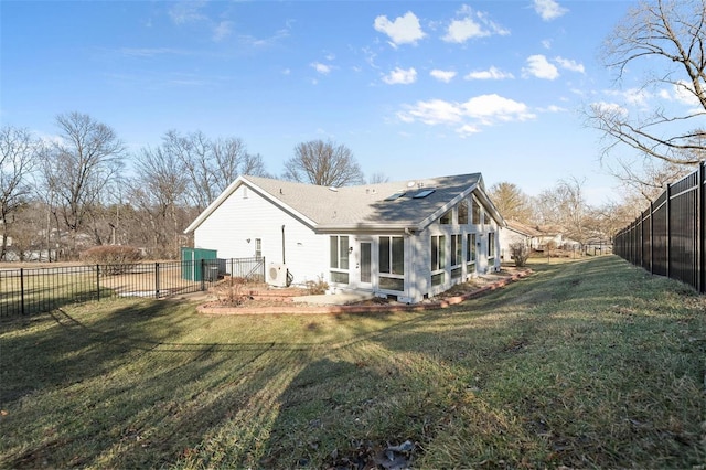 back of property featuring a sunroom, a lawn, and fence