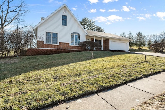 view of front of home with brick siding, a garage, and a front lawn