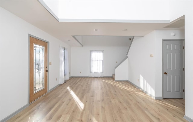 foyer entrance featuring light wood-type flooring and baseboards