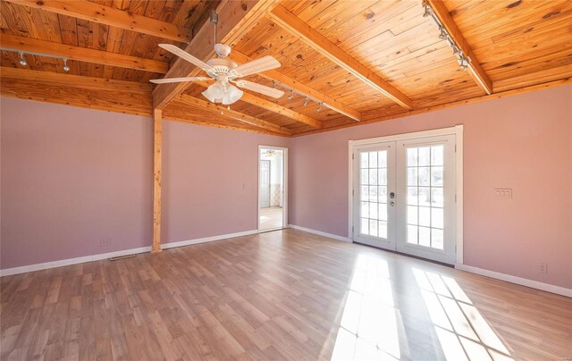 spare room with lofted ceiling with beams, french doors, a ceiling fan, wood ceiling, and rail lighting