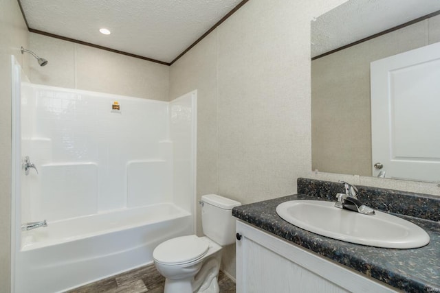 full bathroom with shower / bathing tub combination, vanity, wood-type flooring, a textured ceiling, and toilet