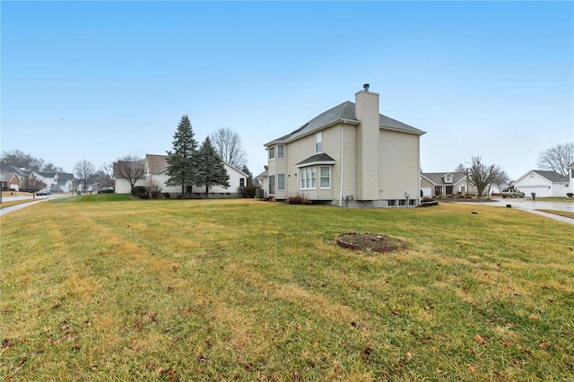 view of side of property featuring a yard