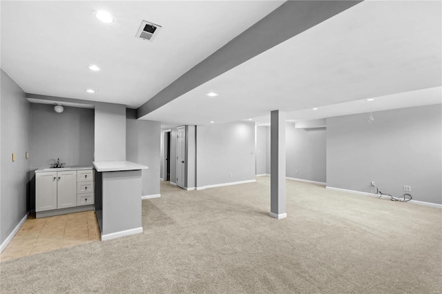 basement featuring light colored carpet