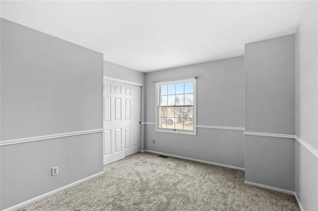 empty room featuring light colored carpet