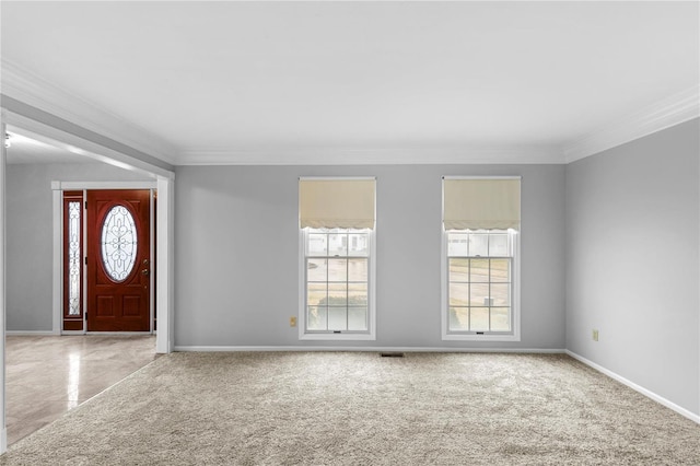 carpeted entrance foyer with ornamental molding