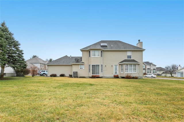 back of property featuring cooling unit and a yard