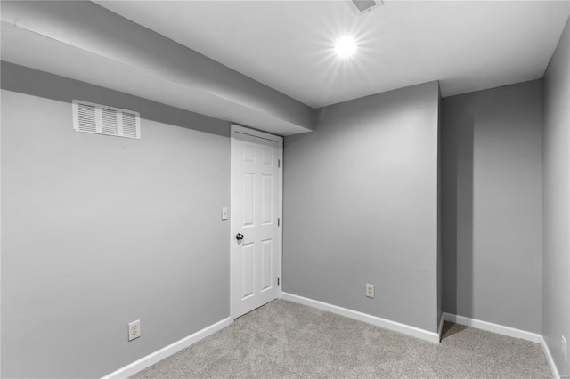 basement featuring light carpet