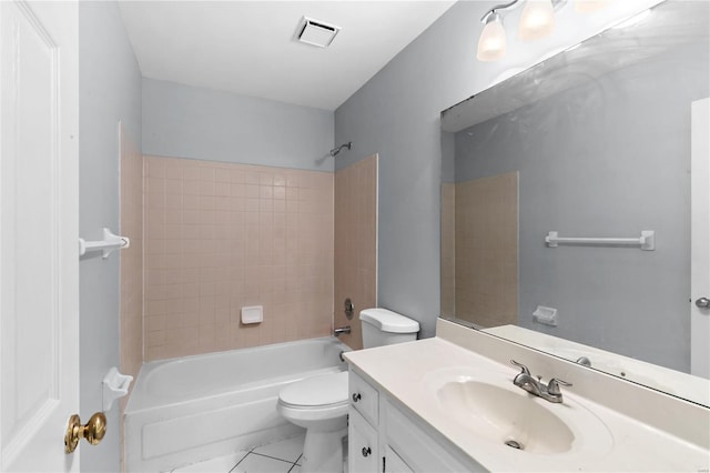 full bathroom featuring tiled shower / bath combo, vanity, tile patterned flooring, and toilet