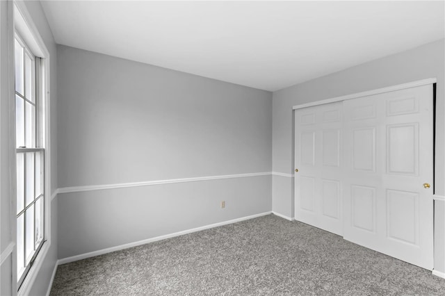 unfurnished bedroom featuring carpet floors and a closet