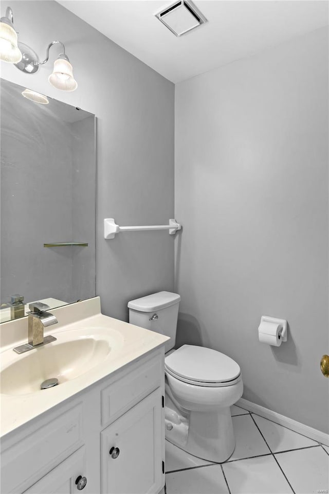 bathroom featuring vanity, tile patterned floors, and toilet