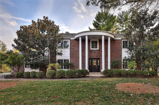 neoclassical home with a front yard