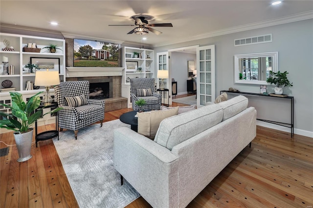 living room featuring hardwood / wood-style flooring, ornamental molding, and french doors