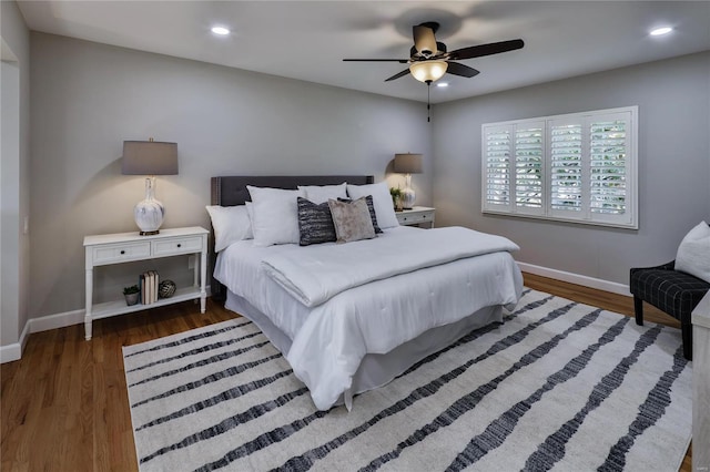 bedroom with dark hardwood / wood-style floors and ceiling fan