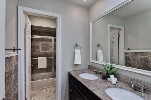 full bathroom with vanity, tile patterned floors, enclosed tub / shower combo, and toilet