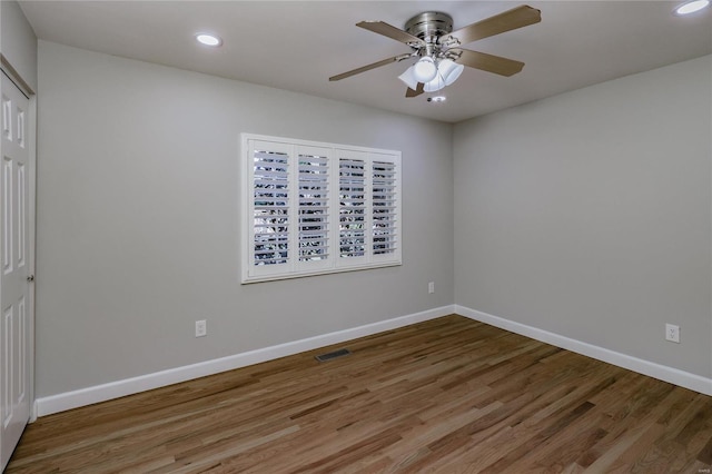 empty room featuring hardwood / wood-style flooring and ceiling fan