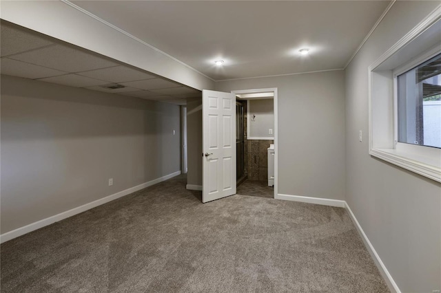 unfurnished bedroom featuring ornamental molding, ensuite bathroom, and carpet