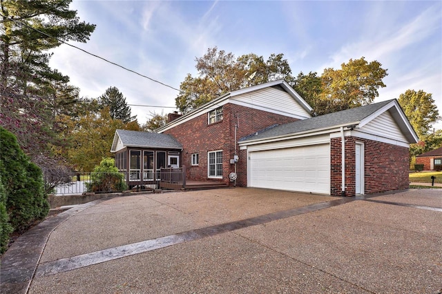 view of front of house featuring a garage and a sunroom