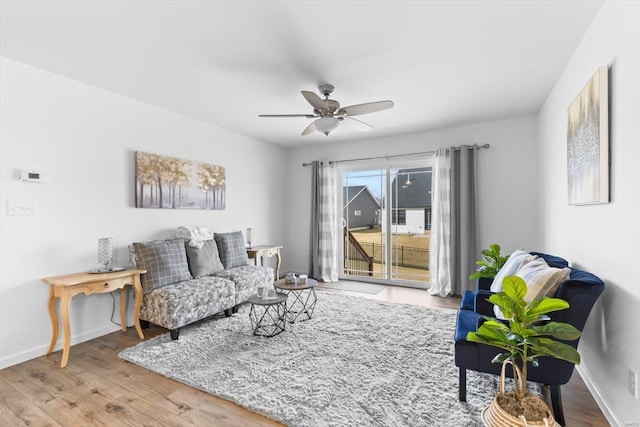 living room with hardwood / wood-style flooring and ceiling fan