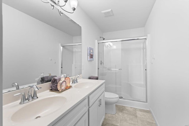 bathroom featuring vanity, toilet, and a shower with door