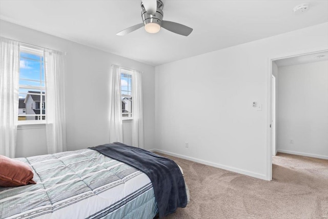 bedroom featuring multiple windows, carpet floors, and ceiling fan