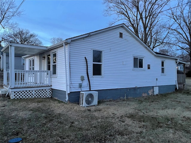 view of home's exterior featuring ac unit and a lawn