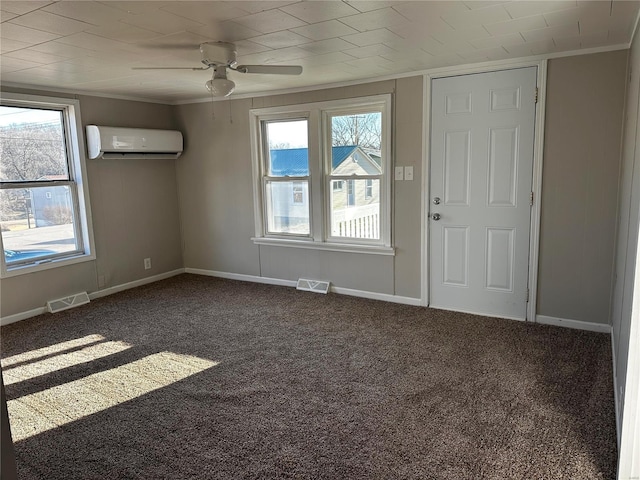 empty room with ornamental molding, carpet flooring, a wall unit AC, and a wealth of natural light