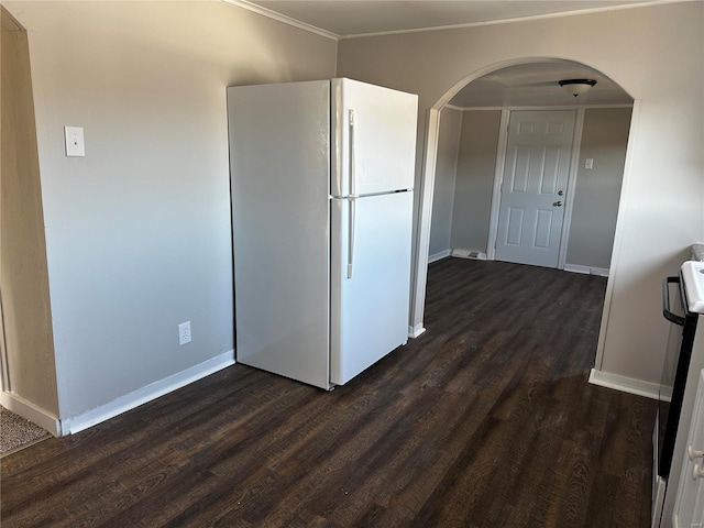 interior space with crown molding, dark hardwood / wood-style flooring, and white fridge