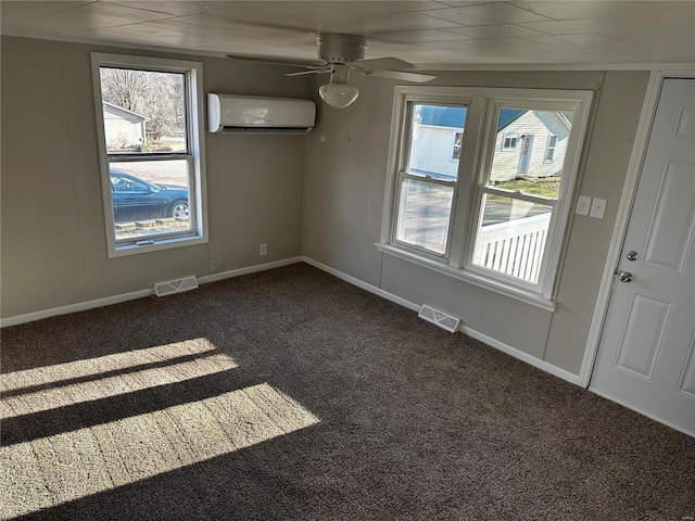 carpeted empty room with an AC wall unit and ceiling fan