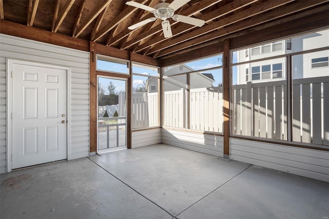 unfurnished sunroom featuring a ceiling fan