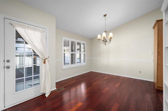 unfurnished dining area featuring wood finished floors, visible vents, baseboards, an inviting chandelier, and vaulted ceiling