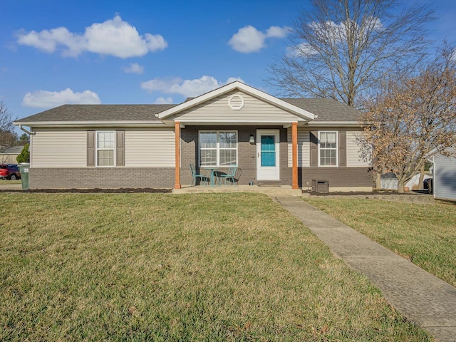 view of front of house with brick siding, roof with shingles, and a front lawn