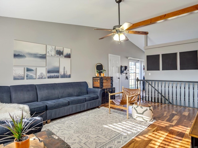 living area with vaulted ceiling with beams, ceiling fan, and wood finished floors