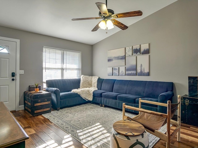 living room featuring wood finished floors, ceiling fan, and vaulted ceiling