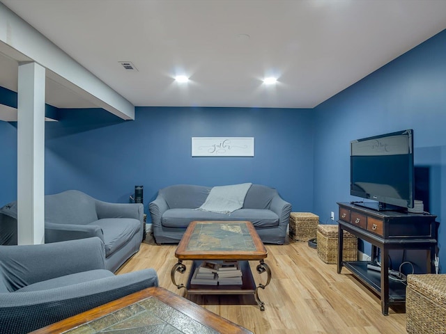 living room with light wood-style flooring and visible vents