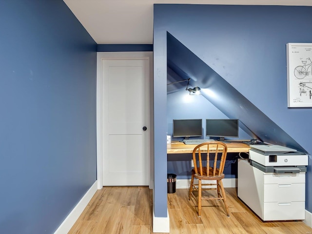 office with light wood-type flooring and baseboards