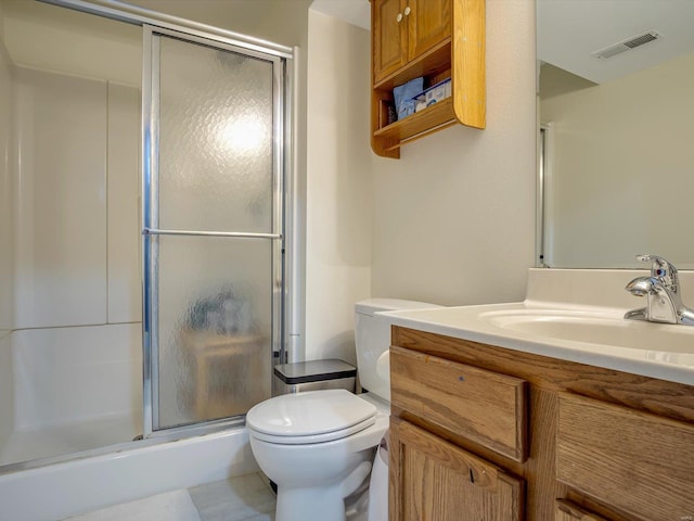 full bath featuring vanity, a shower stall, toilet, and visible vents