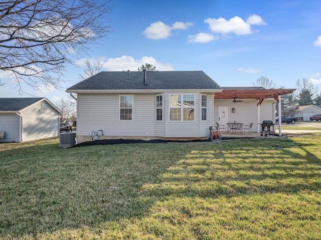 back of house with a patio, cooling unit, roof with shingles, ceiling fan, and a lawn