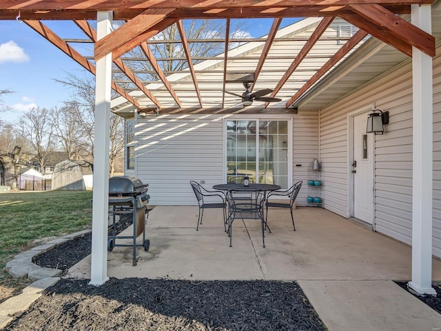 view of patio / terrace featuring grilling area, a shed, outdoor dining area, an outdoor structure, and a pergola