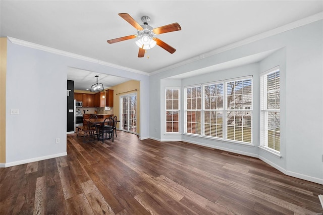 unfurnished living room featuring ceiling fan, ornamental molding, and dark hardwood / wood-style flooring